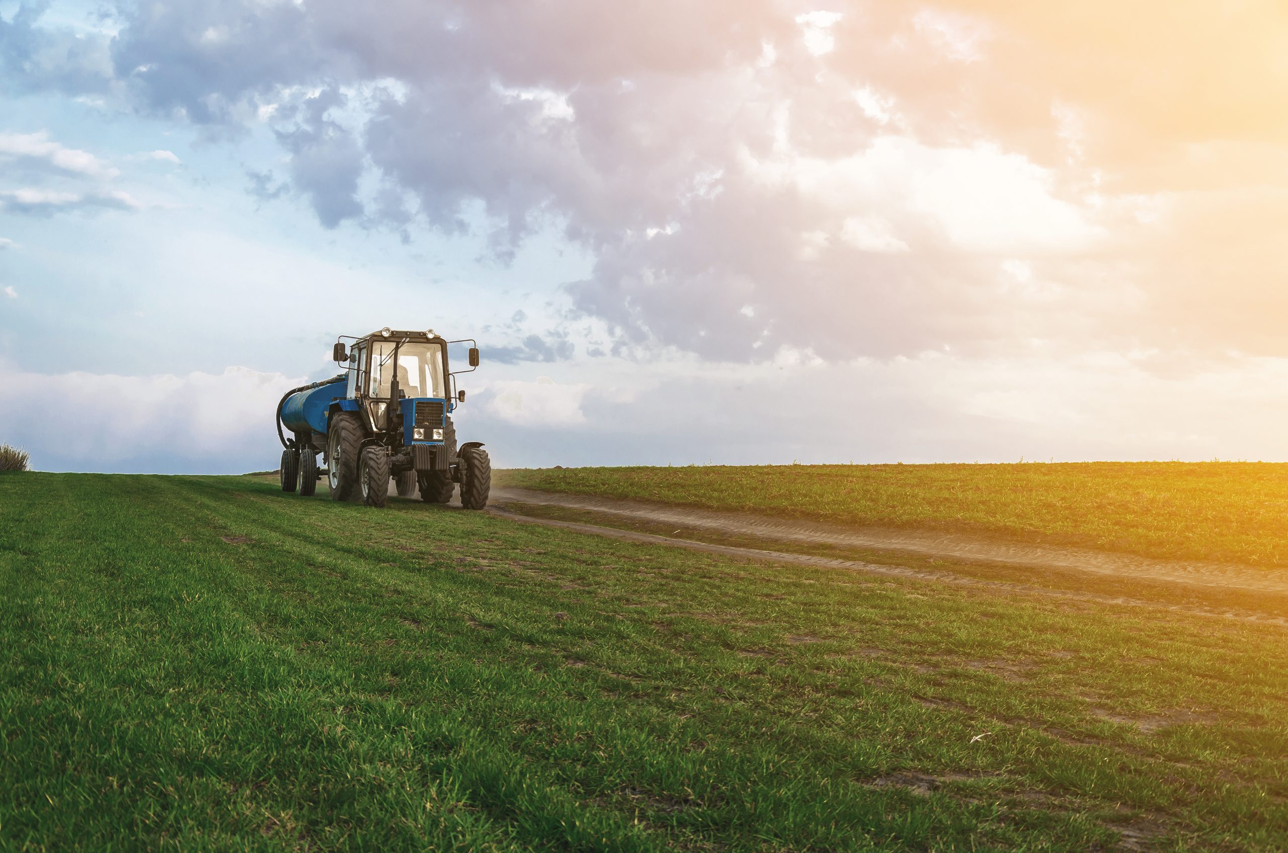 tractor driving on a freshly fertilized agricultural field