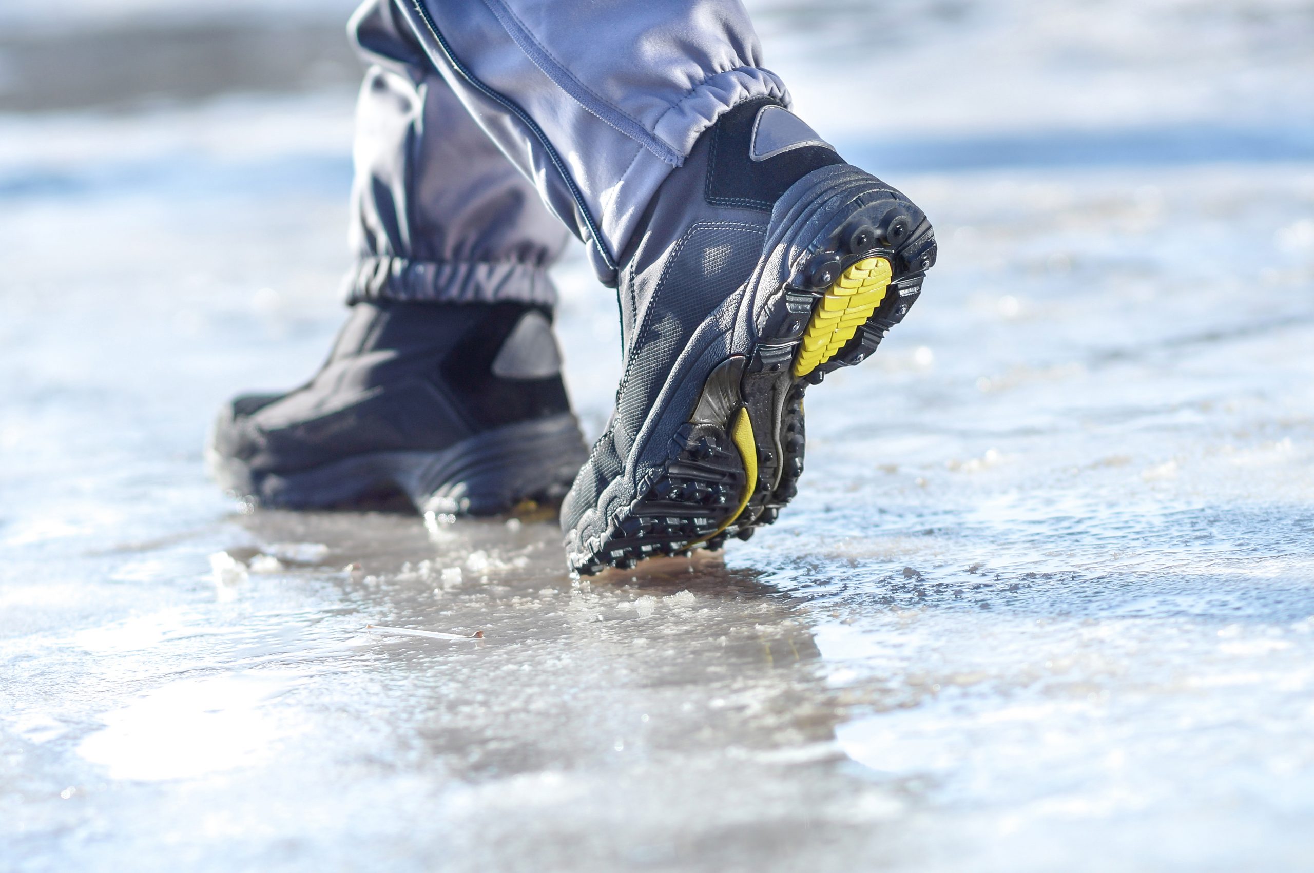 winter boots walking on snowy sleet road